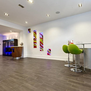 Inspiration for a medium sized modern look-out basement in Toronto with white walls, porcelain flooring, a ribbon fireplace and a tiled fireplace surround.