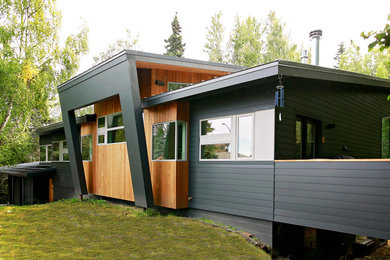 Inspiration for a large contemporary black two-story mixed siding gable roof remodel in Other