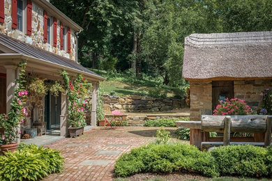 Example of a large mountain style two-story stone gable roof design in New York