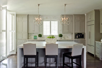 Open concept kitchen - contemporary l-shaped medium tone wood floor open concept kitchen idea in Austin with a farmhouse sink, paneled appliances, an island, marble countertops, white backsplash and stone tile backsplash