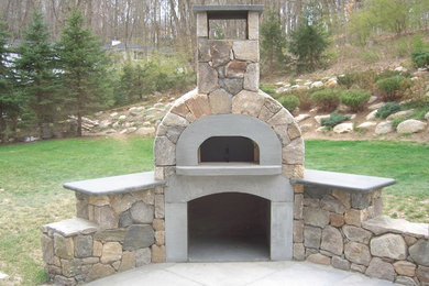 Design ideas for a large arts and crafts backyard patio in New York with an outdoor kitchen, natural stone pavers and no cover.