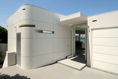 Large contemporary two-storey white exterior in Sydney with metal siding.