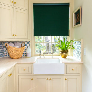 Inspiration for a small traditional l-shaped separated utility room in Raleigh with a belfast sink, shaker cabinets, dark hardwood flooring, yellow worktops, engineered stone countertops, beige cabinets and white walls.