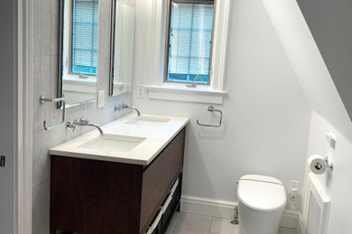 Example of a small minimalist master gray tile and porcelain tile porcelain tile, gray floor and double-sink bathroom design in New York with furniture-like cabinets, brown cabinets, a bidet, gray walls, an undermount sink, quartzite countertops, a hinged shower door, white countertops and a freestanding vanity
