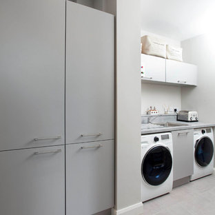 Inspiration for a large modern single-wall utility room in Belfast with flat-panel cabinets.
