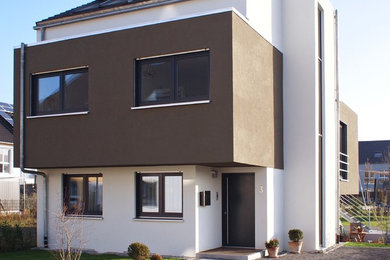 Großes, Dreistöckiges Modernes Haus mit weißer Fassadenfarbe und Satteldach in Sonstige