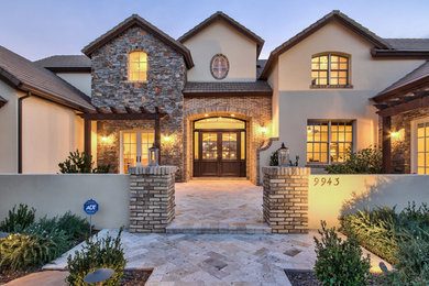 Inspiration for a farmhouse beige two-story mixed siding exterior home remodel in Phoenix with a hip roof