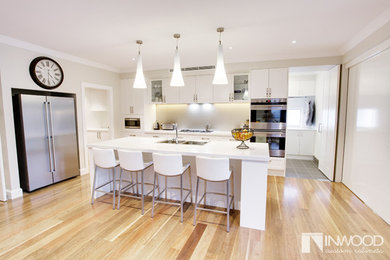 Design ideas for a contemporary eat-in kitchen in Sydney with shaker cabinets and with island.