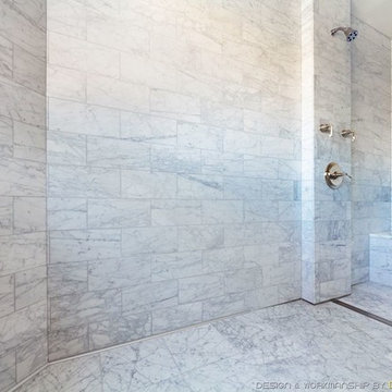 White marble curbless bathroom with custom shower bench