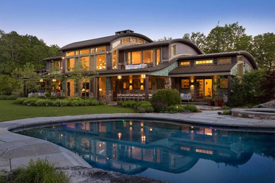 Example of a large trendy backyard stone and custom-shaped natural hot tub design in Bridgeport