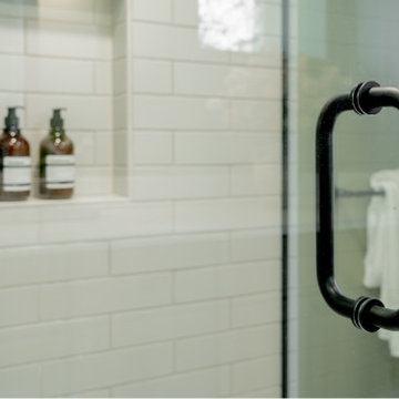 Matte Black Frameless Shower Handle and High-Contrast Subway Tile