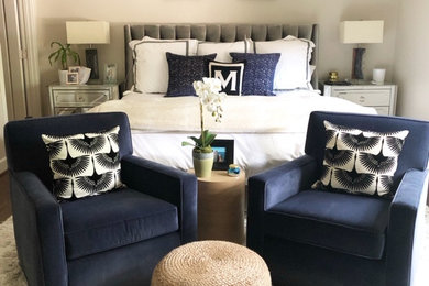 Example of a trendy master dark wood floor and brown floor bedroom design in Dallas with gray walls and no fireplace