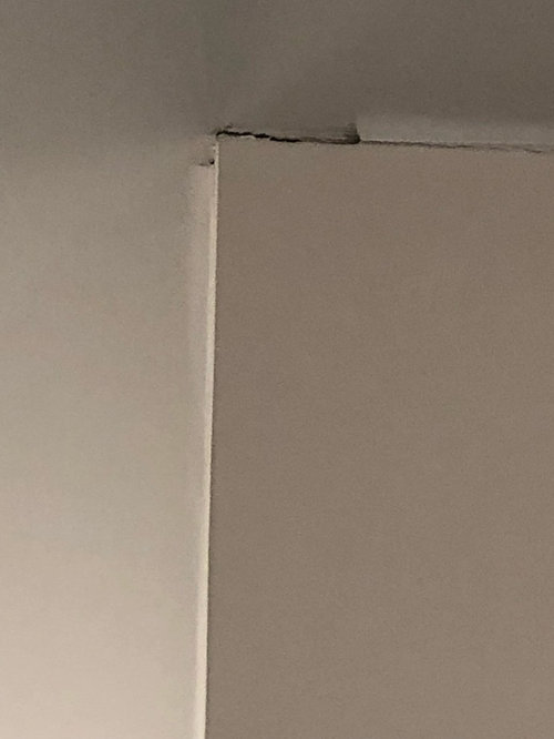New construction cracking/separation at wall and ceiling