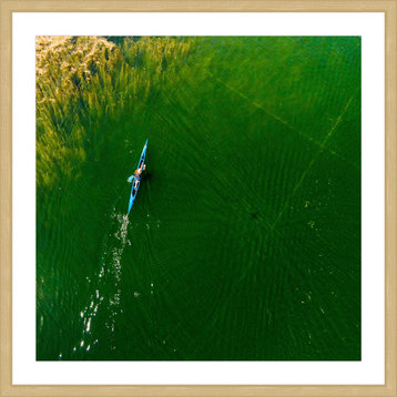 "Blue Canoe" Framed Print by Karolis Janulis