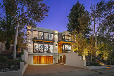 Large contemporary three-storey white house exterior in Denver with a flat roof.