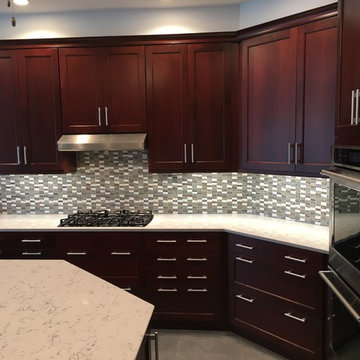 Bright kitchen with dark cabinets and white countertops, cooking zone
