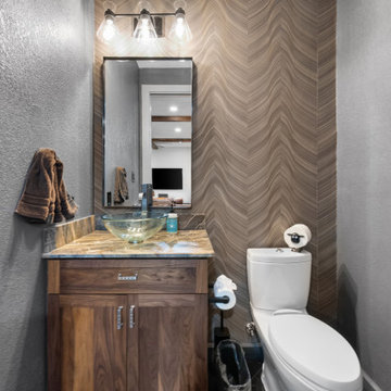Frontal view of walnut bathroom vanity with granite top and waterfall faucet