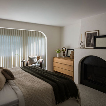 Primary Bedroom with Arched Venetian Plaster Fireplace | Organic Modern