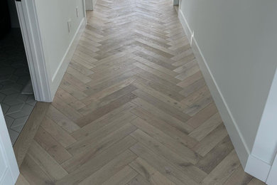 Inspiration for a mid-sized scandinavian light wood floor and beige floor hallway remodel in Vancouver with white walls