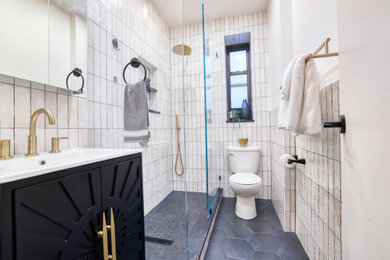 Small minimalist master beige tile and ceramic tile ceramic tile, black floor and single-sink bathroom photo in New York with furniture-like cabinets, black cabinets, a one-piece toilet, white walls, an integrated sink, quartz countertops, white countertops and a freestanding vanity