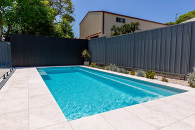 Design ideas for a mid-sized contemporary side yard rectangular pool in Newcastle - Maitland with with a pool and natural stone pavers.