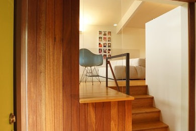 Entryway - small modern slate floor entryway idea in Philadelphia with brown walls and a yellow front door