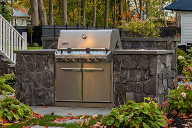 This is an example of a contemporary back patio in New York with an outdoor kitchen.