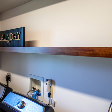 Laundry Room with Custom Cabinetry Quartz Countertop and Custom Floating Shelf