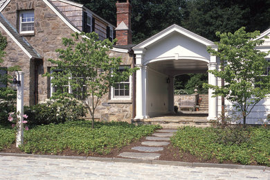 Small country two-storey exterior in New York with stone veneer.