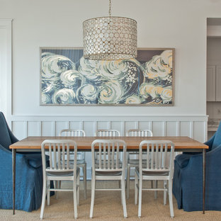 Inspiration for a beach style medium tone wood floor and brown floor dining room remodel in Other with gray walls