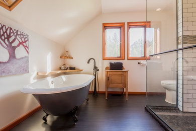Photo of a large contemporary master bathroom in Calgary with flat-panel cabinets, light wood cabinets, a claw-foot tub, a corner shower, a two-piece toilet, beige walls, a drop-in sink and a hinged shower door.