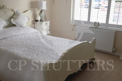 Inspiration for a medium sized vintage master bedroom in Essex with beige walls and carpet.