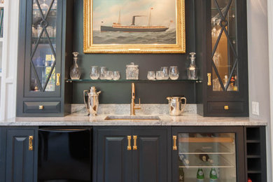 Inspiration for a small timeless single-wall medium tone wood floor and brown floor wet bar remodel in New York with an undermount sink, raised-panel cabinets, blue cabinets and granite countertops