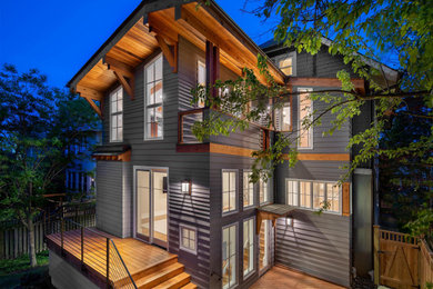 Inspiration for a large gray two-story mixed siding and shingle house exterior remodel in New York with a gambrel roof, a shingle roof and a black roof
