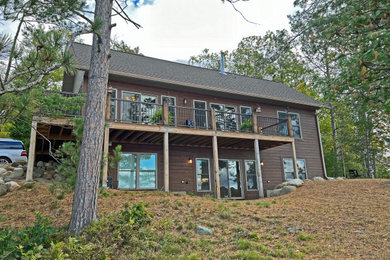 Example of a classic two-story wood and clapboard exterior home design in Other with a shingle roof