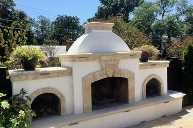 Mid-sized tuscan backyard stone patio photo in DC Metro with a fire pit and a pergola