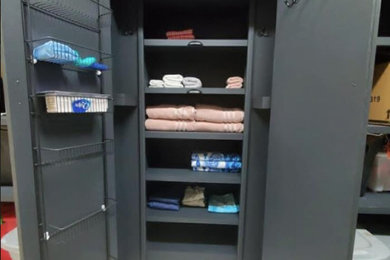 Example of an arts and crafts ceramic tile and white floor built-in closet design in Austin with dark wood cabinets