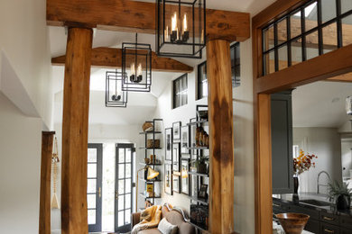 Foyer - large transitional dark wood floor and exposed beam foyer idea in San Francisco with white walls