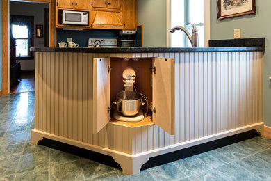 Kitchen - cottage ceramic tile kitchen idea in Other with white cabinets, granite countertops and an island