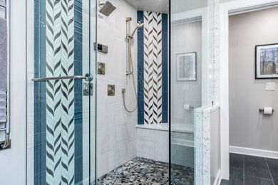 Example of a large transitional master multicolored tile and porcelain tile porcelain tile, blue floor and double-sink corner shower design in Chicago with shaker cabinets, dark wood cabinets, a two-piece toilet, gray walls, an undermount sink, quartz countertops, a hinged shower door, white countertops, a niche and a floating vanity