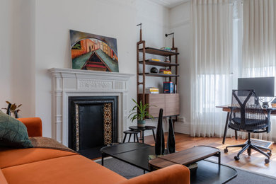 This is an example of a retro home office in London with a freestanding desk.