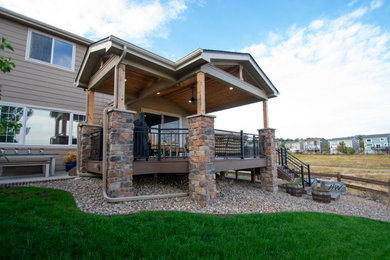 Mid-sized transitional backyard second story metal railing deck photo in Denver with a fire pit and a roof extension