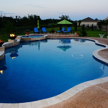 Freeform travertine pool with New Orleans Flair