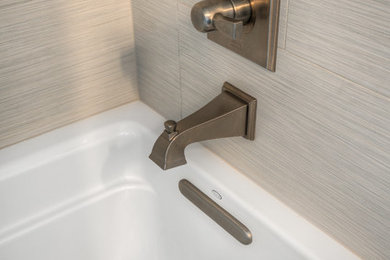 Tub/shower combo - mid-sized transitional master white tile concrete floor tub/shower combo idea in Seattle with recessed-panel cabinets, white cabinets, an undermount tub, a one-piece toilet, white walls, an undermount sink and quartzite countertops