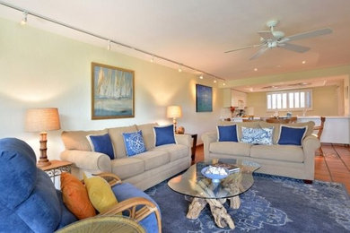 Living room - large coastal open concept ceramic tile and brown floor living room idea in Miami with beige walls and no fireplace