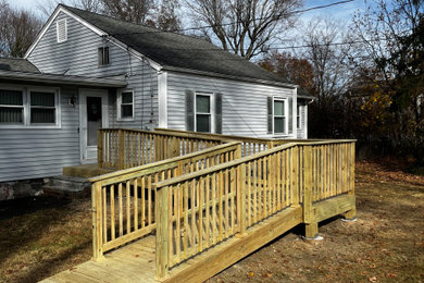Inspiration for a mid-sized wood railing front porch remodel in New York