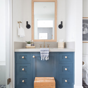 Coastal black floor alcove shower photo in Orange County with shaker cabinets, blue cabinets, white walls, an undermount sink and gray countertops