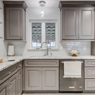 Mid-sized modern kitchen pantry appliance - Mid-sized minimalist l-shaped porcelain floor kitchen pantry photo in Dallas with a drop-in sink, gray cabinets, granite countertops, gray backsplash, glass tile backsplash, black appliances, raised-panel cabinets, no island and gray countertops