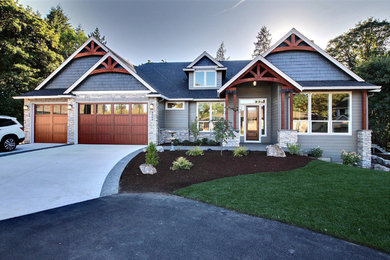 Inspiration for a large craftsman black split-level mixed siding house exterior remodel in Portland with a shingle roof and a hip roof