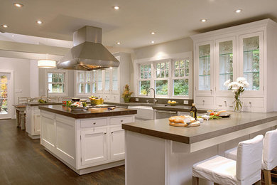 Large elegant l-shaped dark wood floor and brown floor open concept kitchen photo in New York with an integrated sink, shaker cabinets, white cabinets, solid surface countertops, brown backsplash, stone slab backsplash, stainless steel appliances and an island